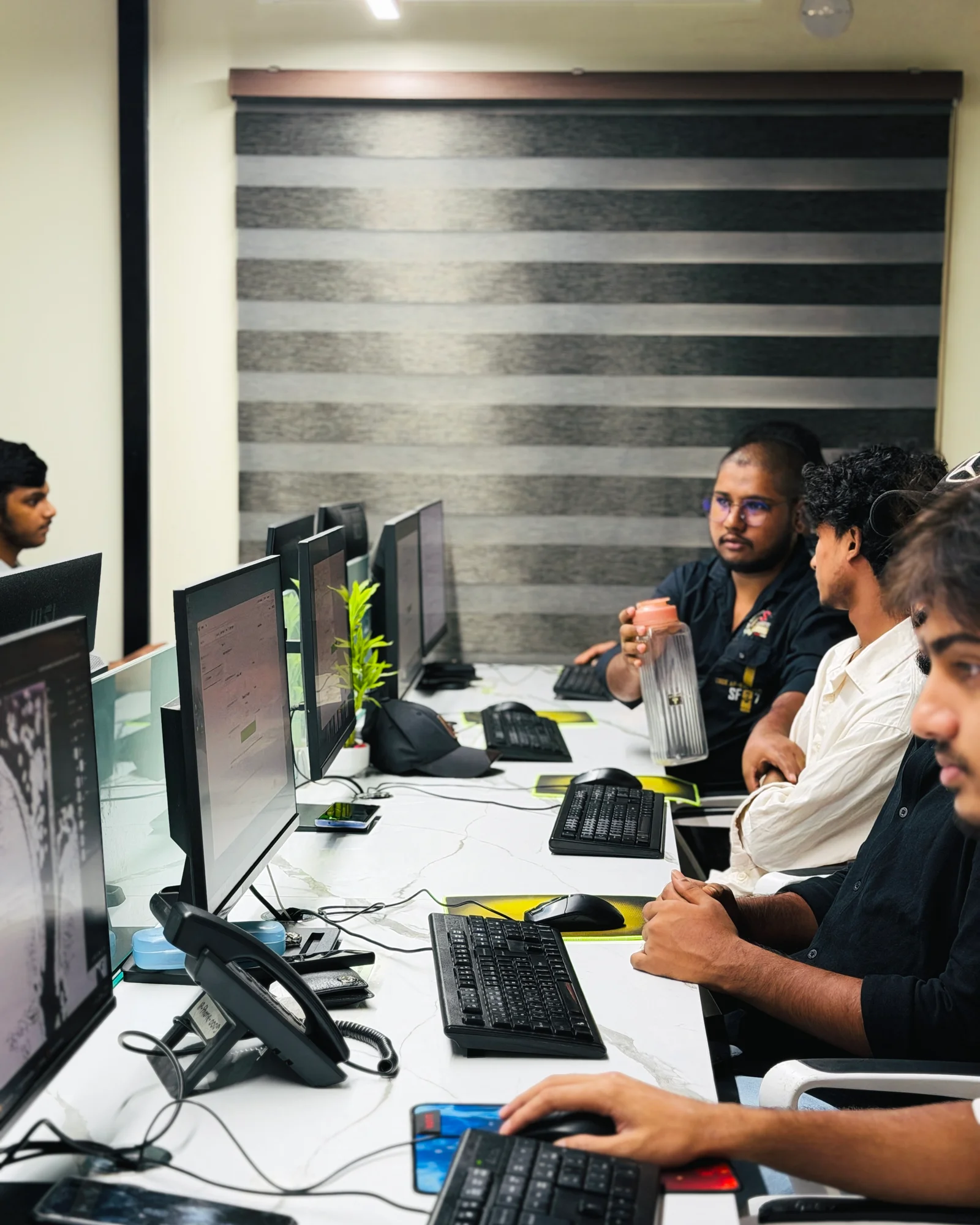 Admin and operations management team supervising floor workflows and shift capacity at Studio Click House