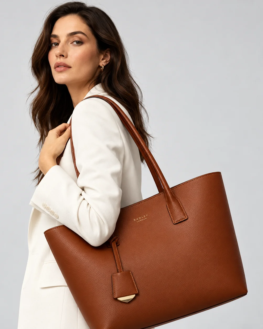 Generative AI fashion model carrying the brown leather handbag in studio lookbook