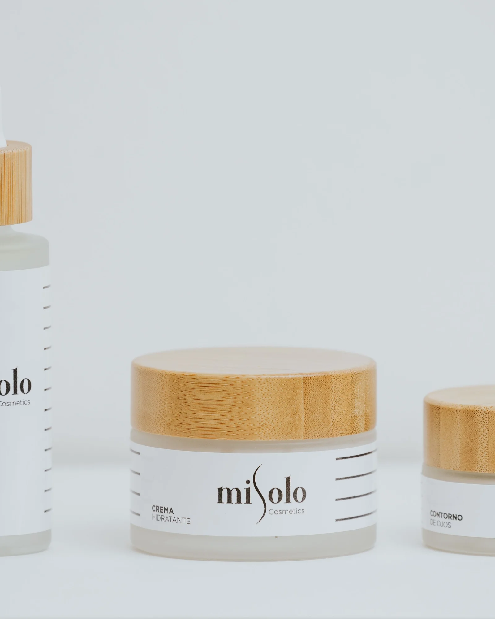 Misolo skincare serum and bamboo cream jars arranged as a product trio