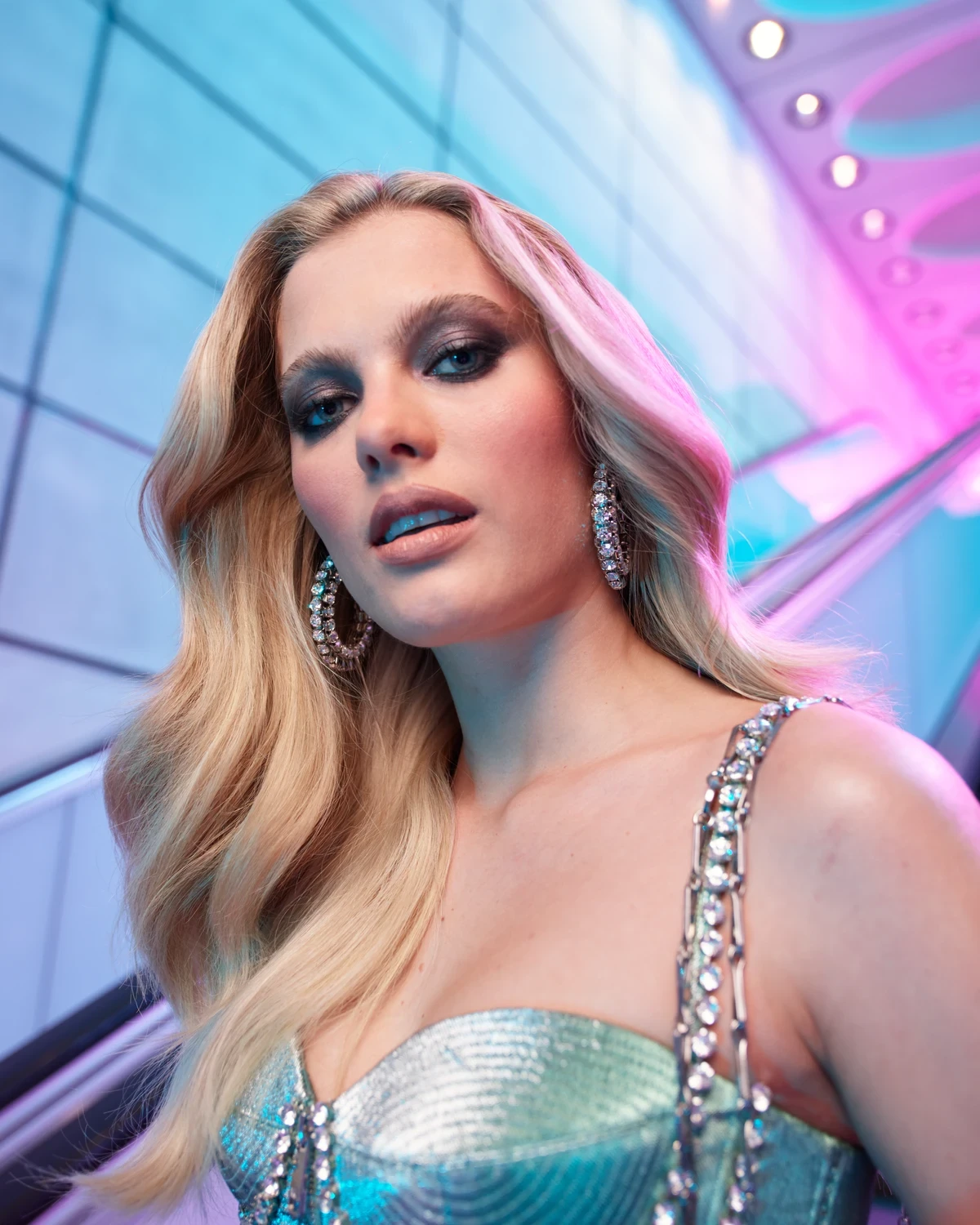 Beauty fashion editorial portrait with crystal styling and neon escalator lighting