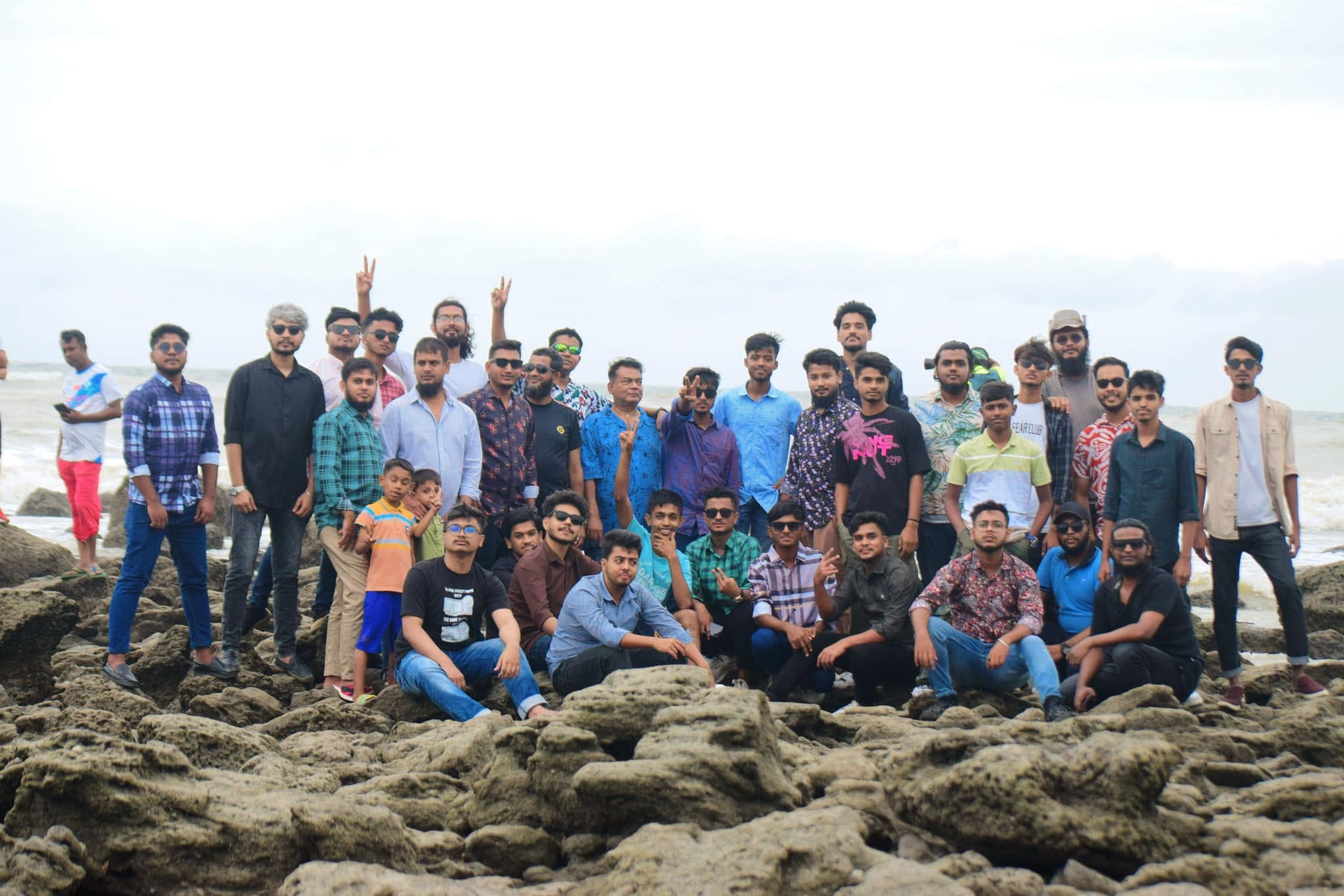 Studio Click House colleagues walking barefoot on Cox's Bazar sand
