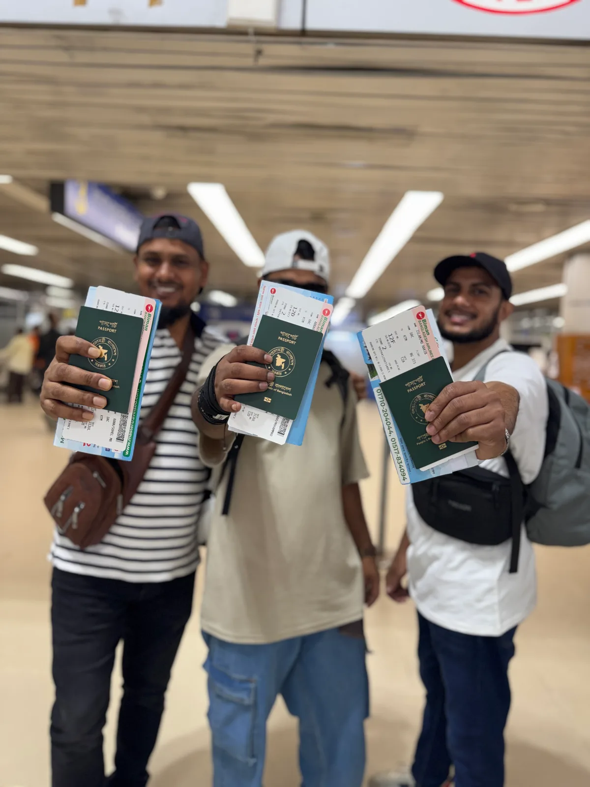 Studio Click House team members displaying passports and boarding passes at airport