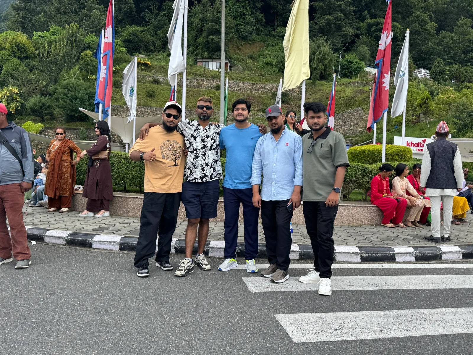 Studio Click House team posing at historic plaza with Nepal flags