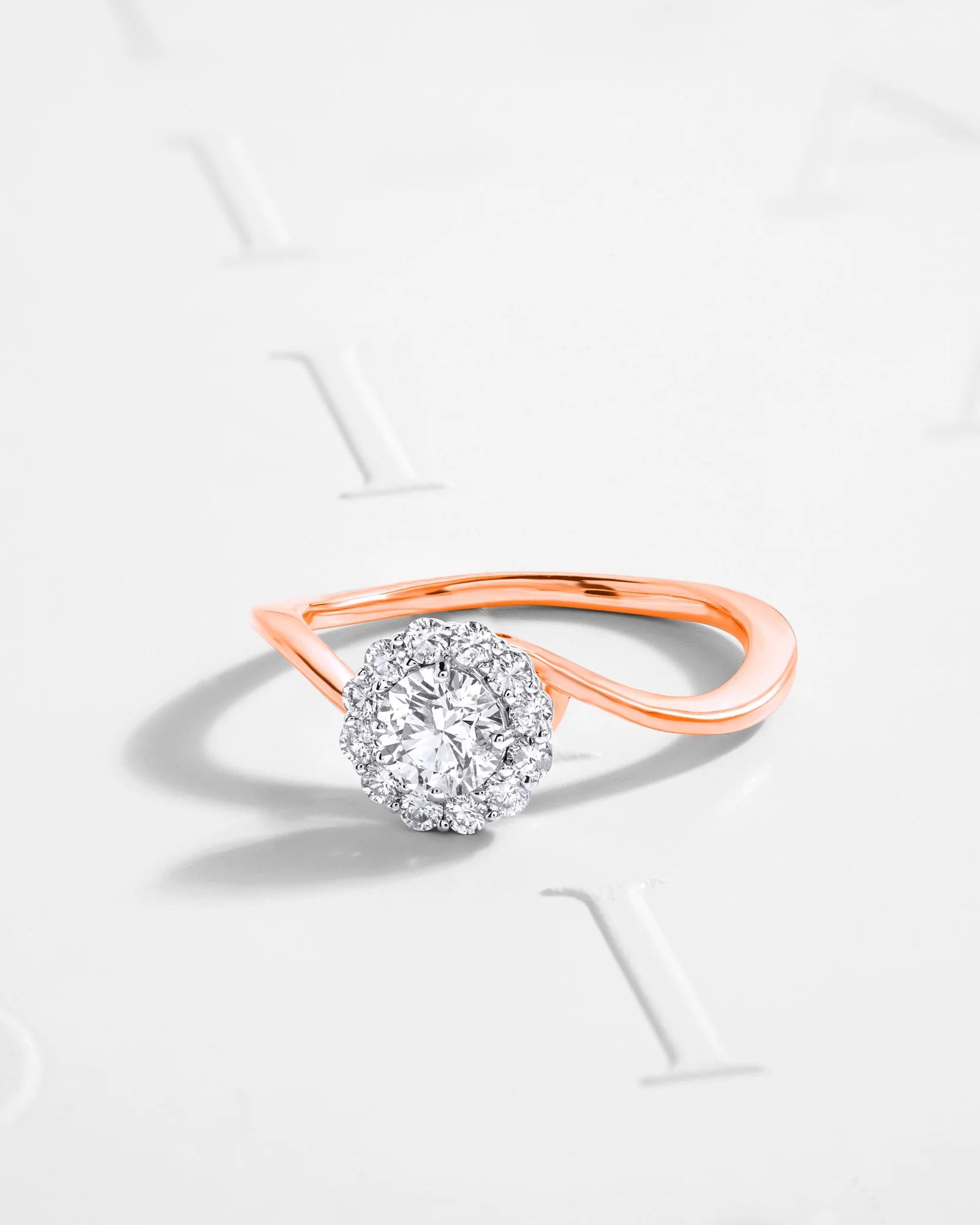 Rose gold solitaire halo ring with a twisted band