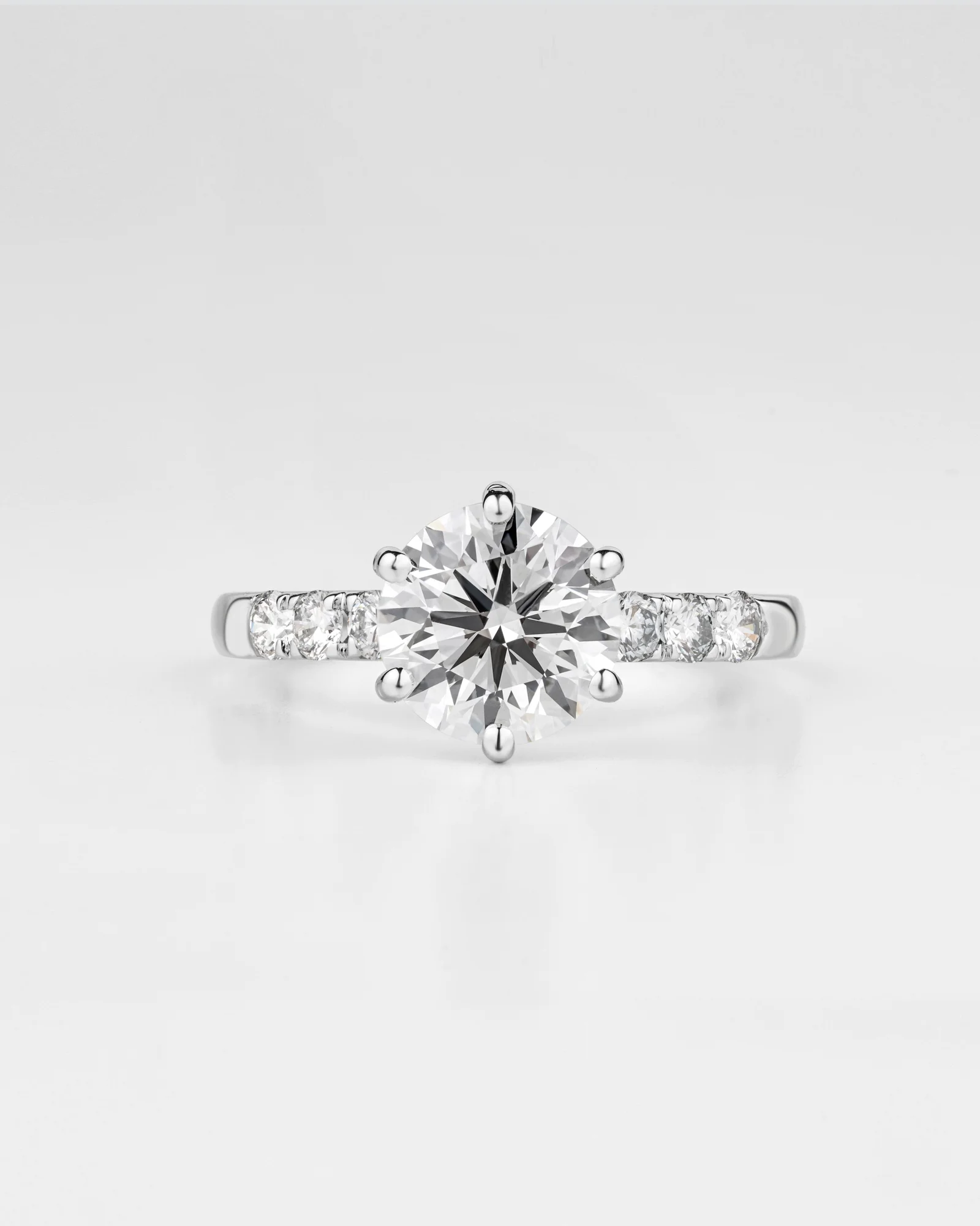 Round brilliant solitaire diamond ring in a studio product image